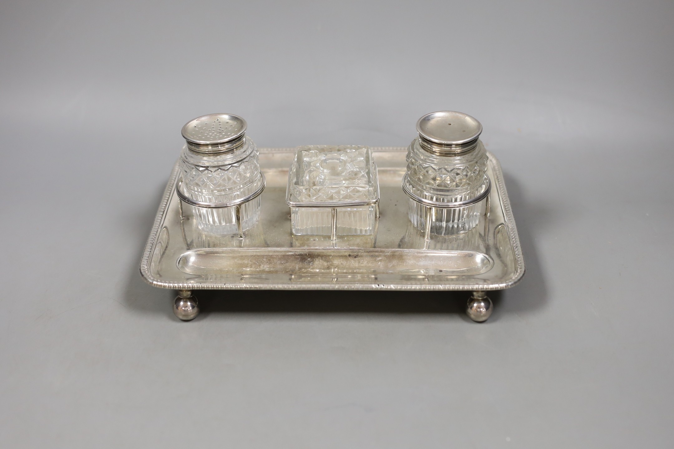 A George III silver rectangular inkstand, with three mounted cut glass wells, Matthew Bolton, Birmingham, 1807, 22.5cm, 13.5oz.